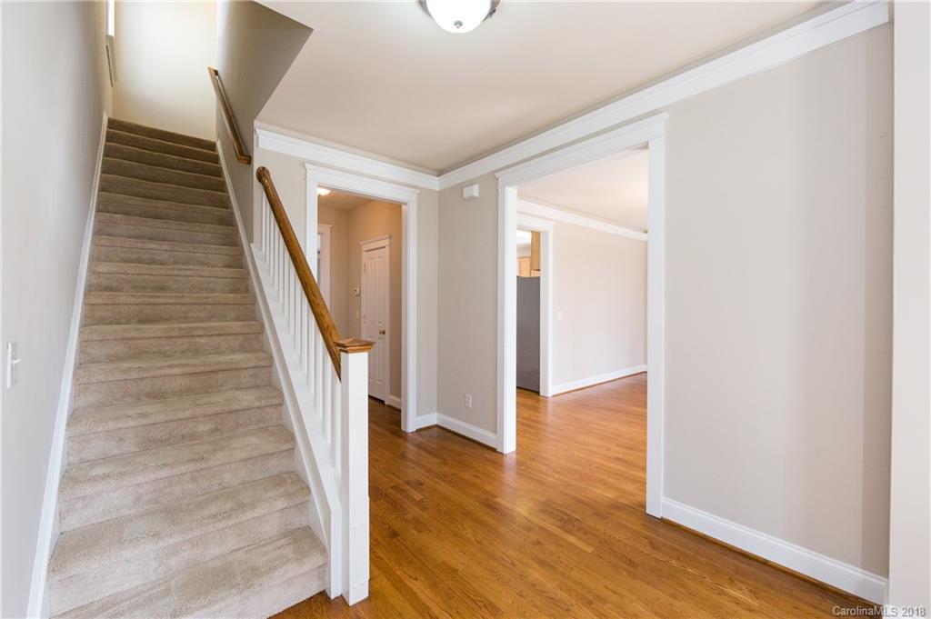 17530 Invermere Avenue Huntersville, NC 28078 - Photo 5 of 36 a view of a hallway with wooden floor and staircase
