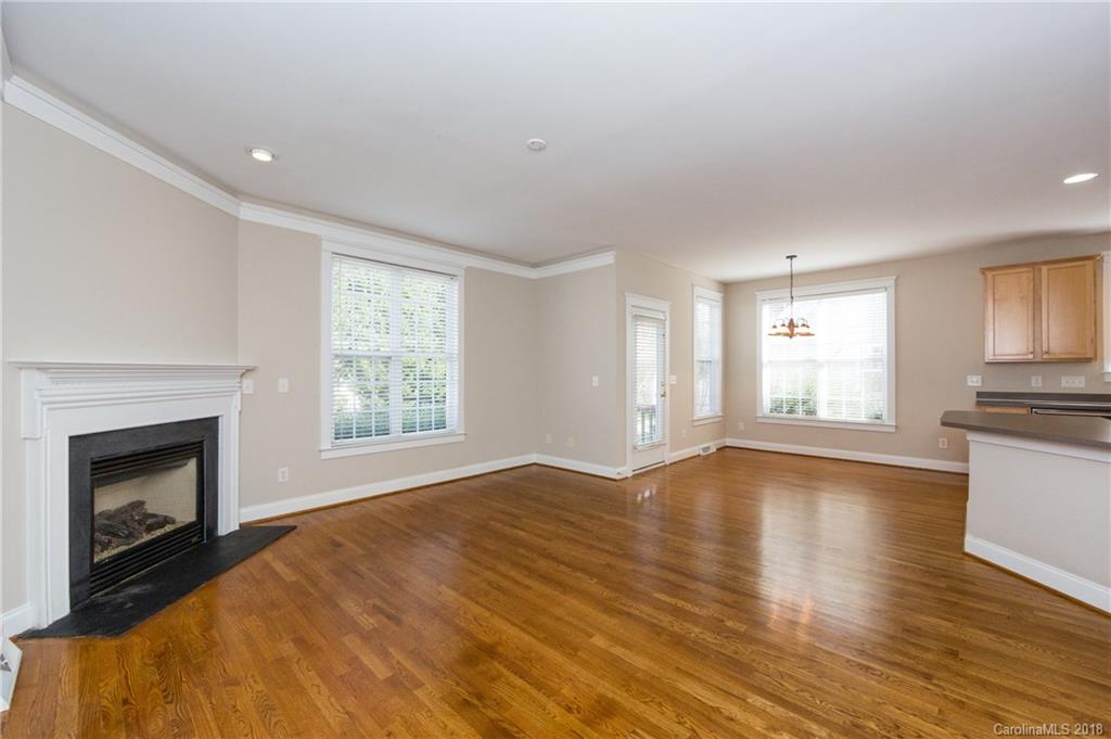 17530 Invermere Avenue Huntersville, NC 28078 - Photo 10 of 36 a view of empty room with wooden floor and fireplace