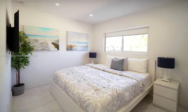 a bedroom with a bed and a potted plant