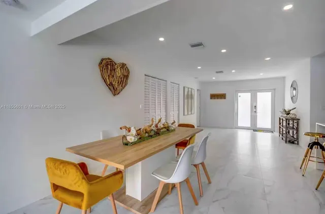 a view of a dining room with furniture and a chandelier