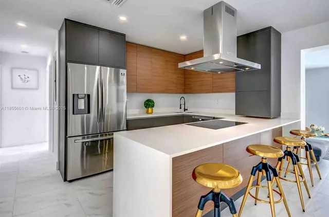 a kitchen with stainless steel appliances granite countertop a sink and a refrigerator