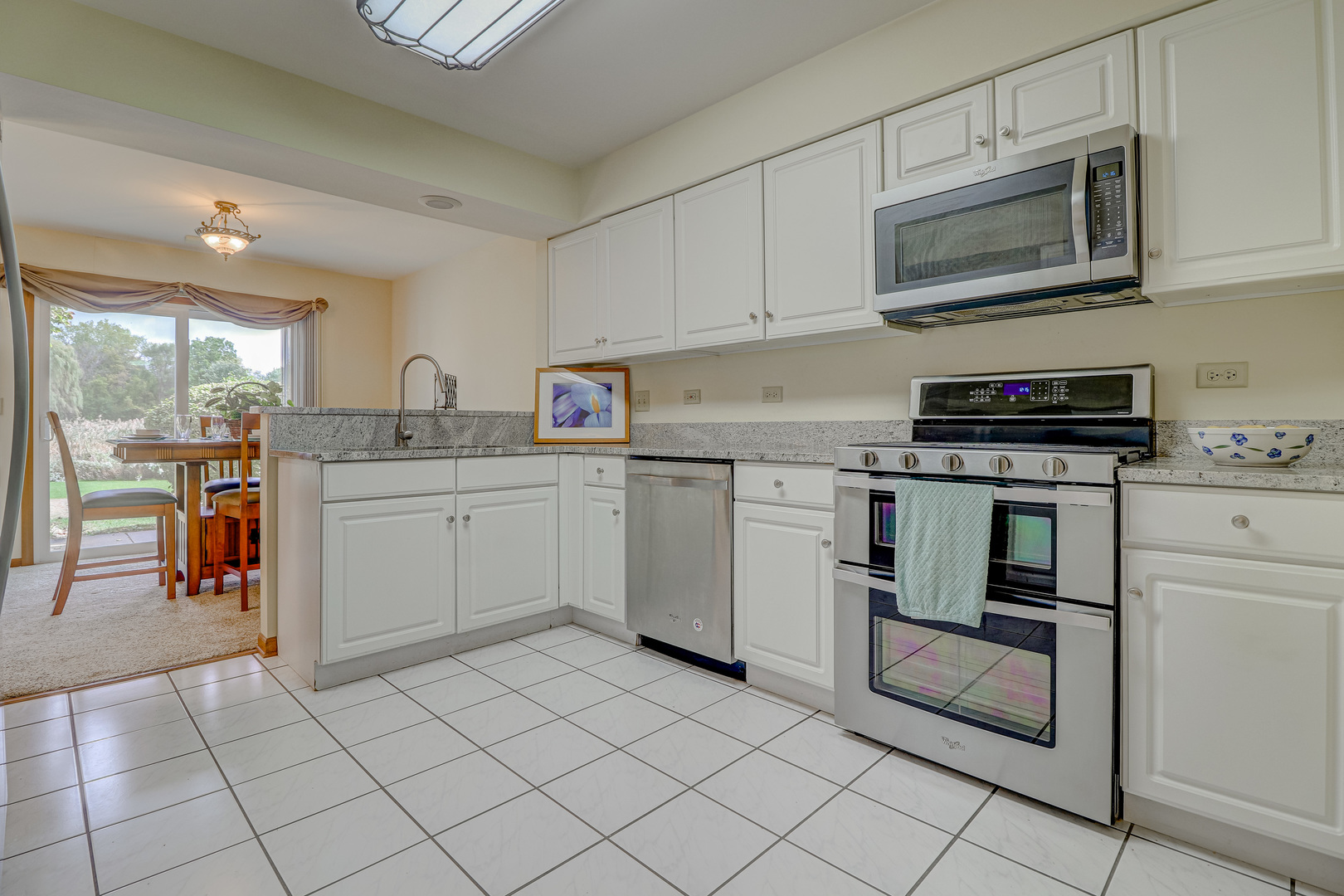 1230 Coldspring Road Elgin, IL 60120 - Photo 3 of 30 a kitchen with a stove sink and cabinets