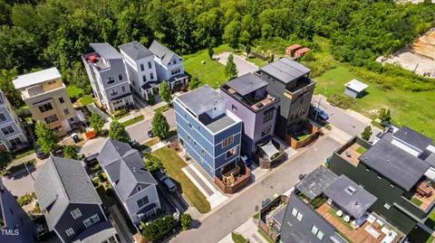 an aerial view of residential houses with outdoor space