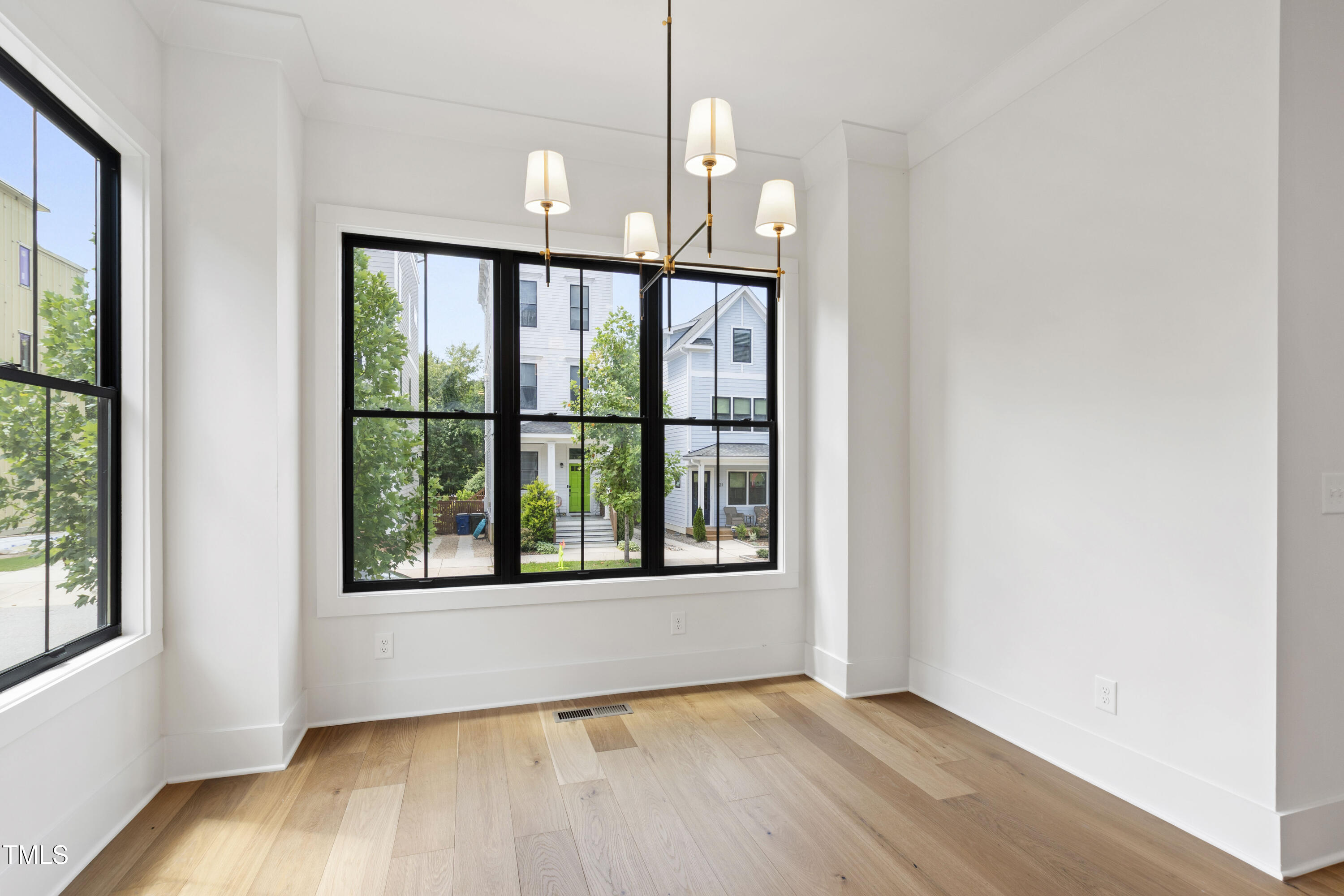 618 Velma Hopkins Lane Raleigh, NC 27603 - Photo 29 of 63 a view of an empty room with wooden floor and a window