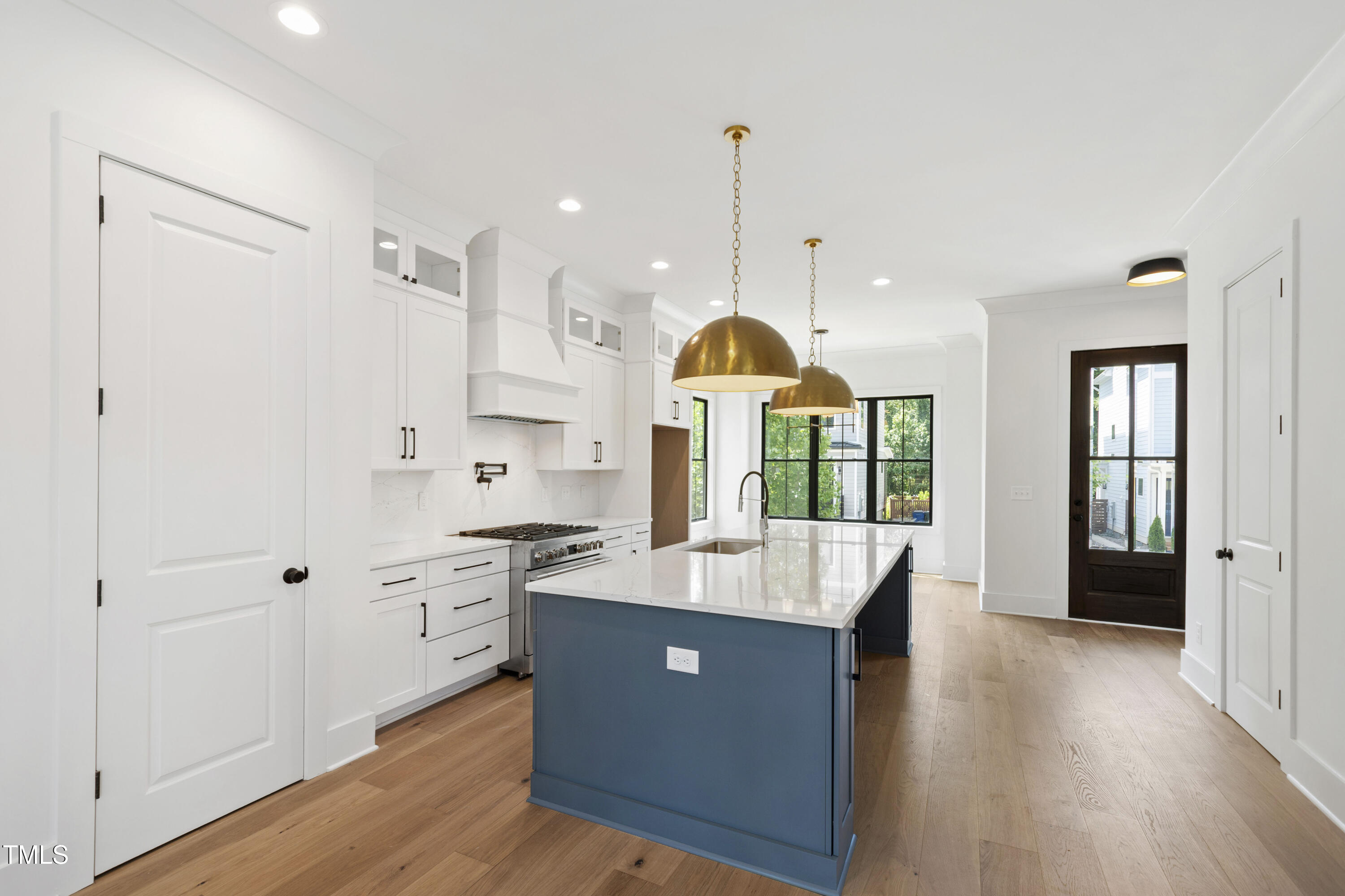 618 Velma Hopkins Lane Raleigh, NC 27603 - Photo 32 of 63 a large kitchen with kitchen island a large counter space and stainless steel appliances