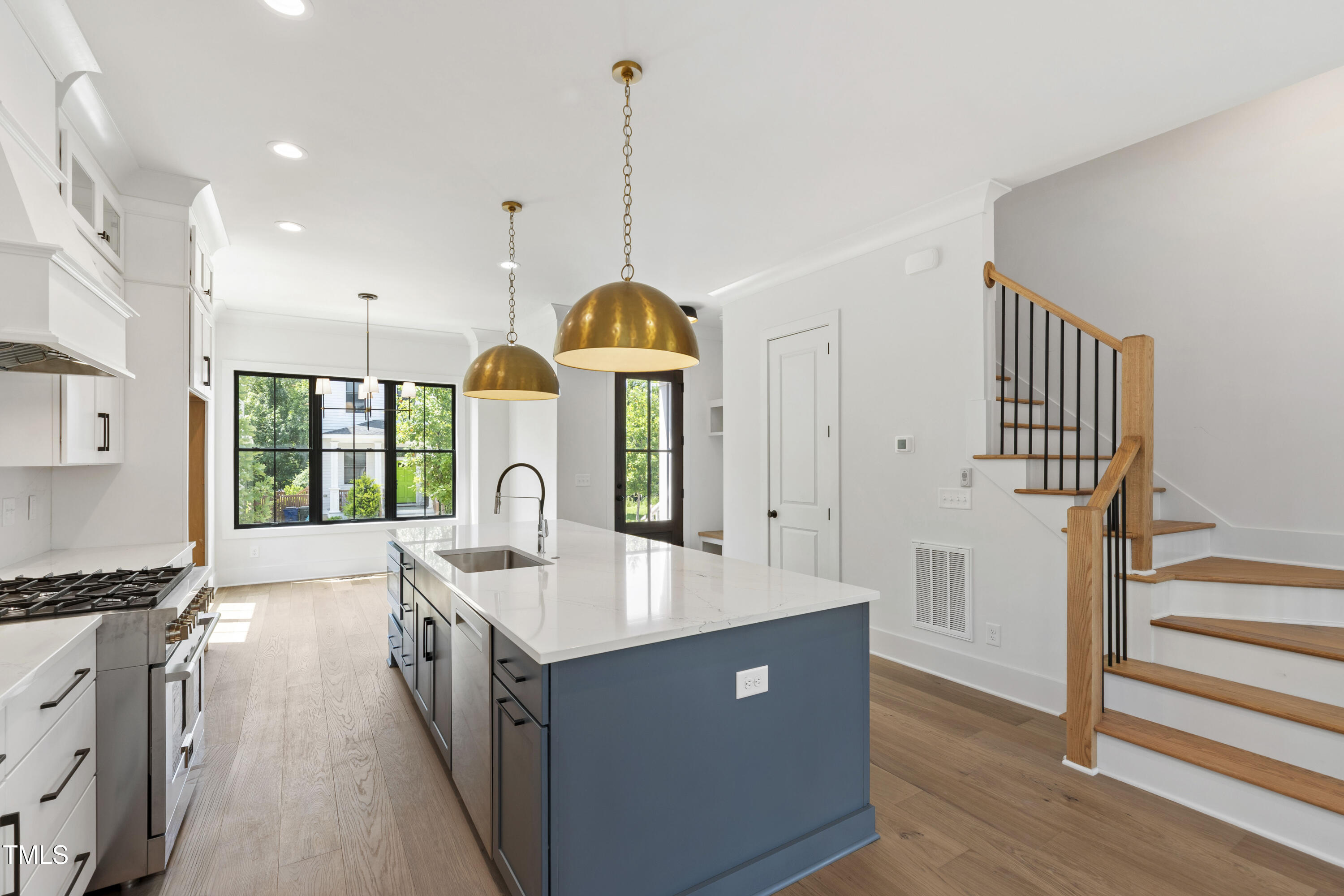 618 Velma Hopkins Lane Raleigh, NC 27603 - Photo 33 of 63 a kitchen with stainless steel appliances granite countertop a sink a stove and a wooden floors