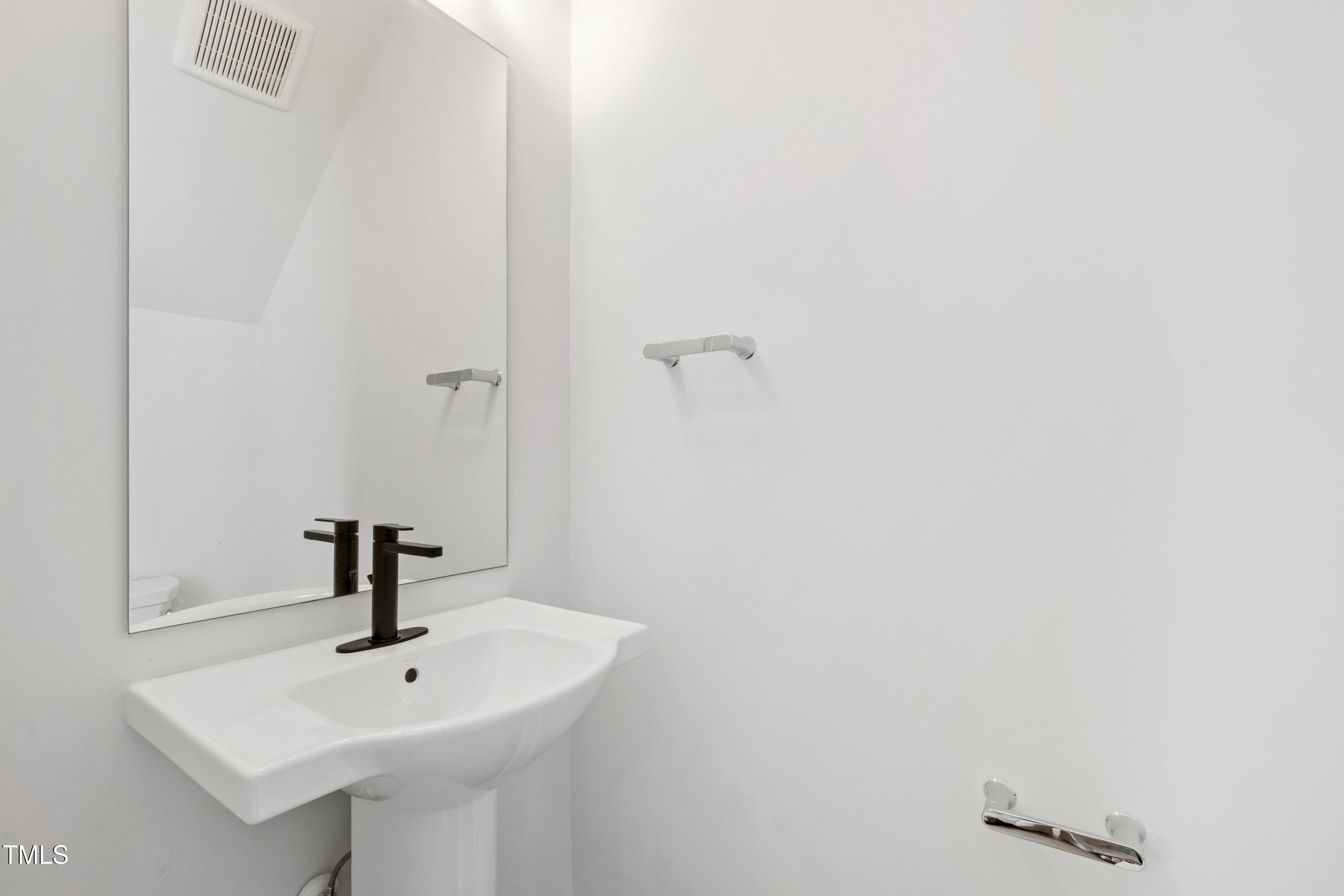 618 Velma Hopkins Lane Raleigh, NC 27603 - Photo 35 of 63 a bathroom with a sink and mirror