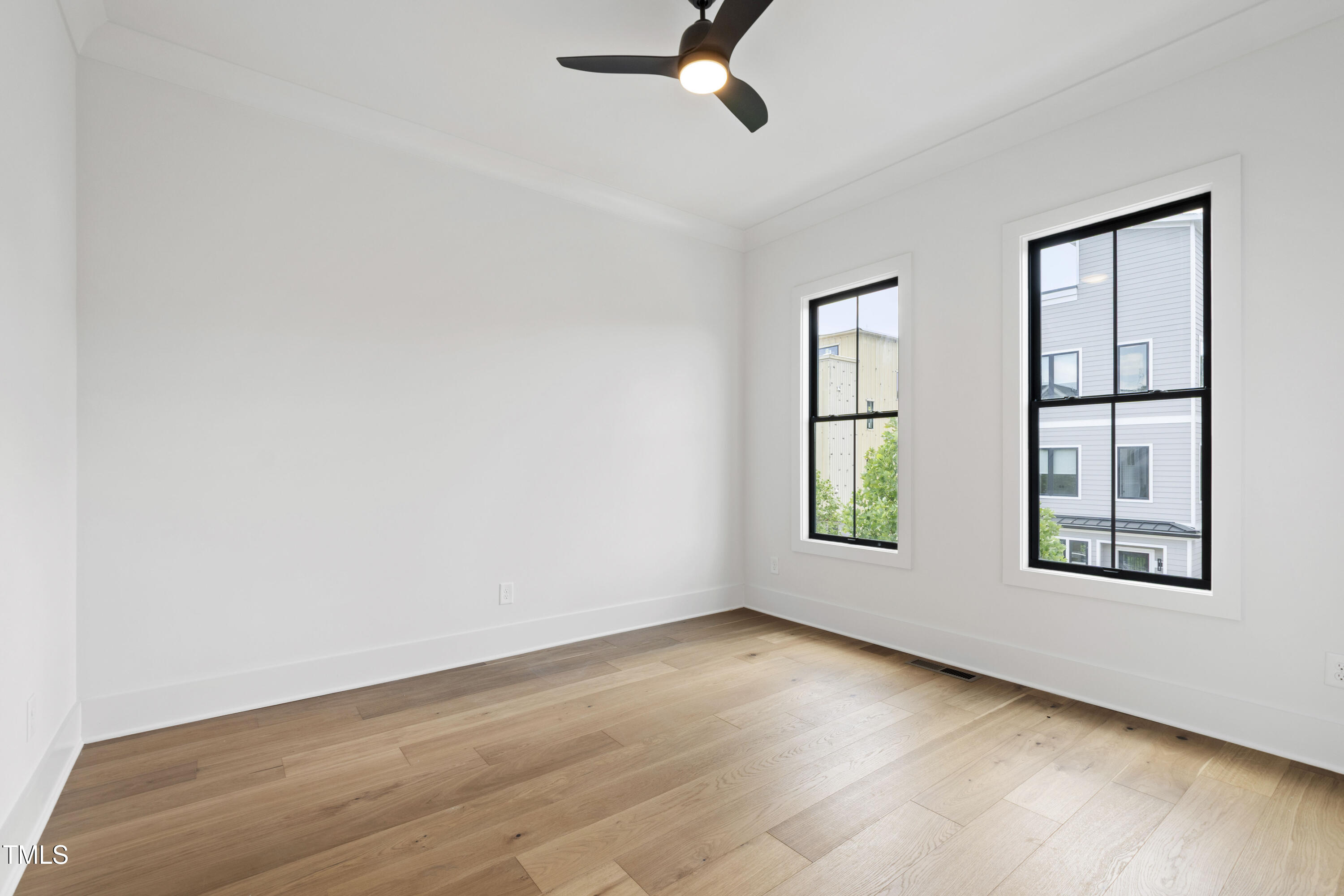 618 Velma Hopkins Lane Raleigh, NC 27603 - Photo 39 of 63 an empty room with windows and fan