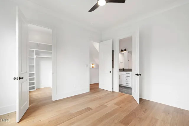 a view of a hallway with wooden floor and staircase