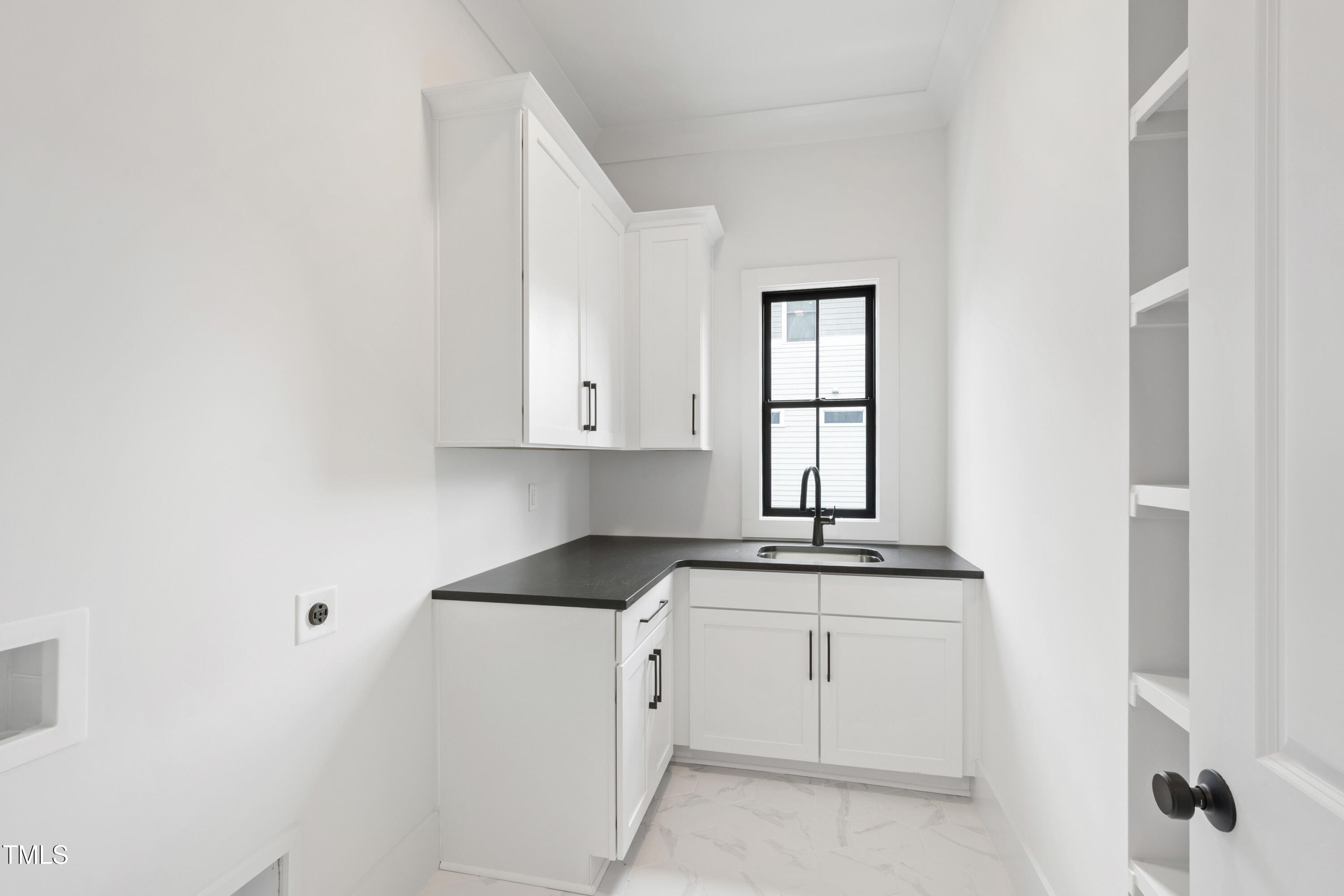 618 Velma Hopkins Lane Raleigh, NC 27603 - Photo 45 of 63 a kitchen with white cabinets appliances and a window