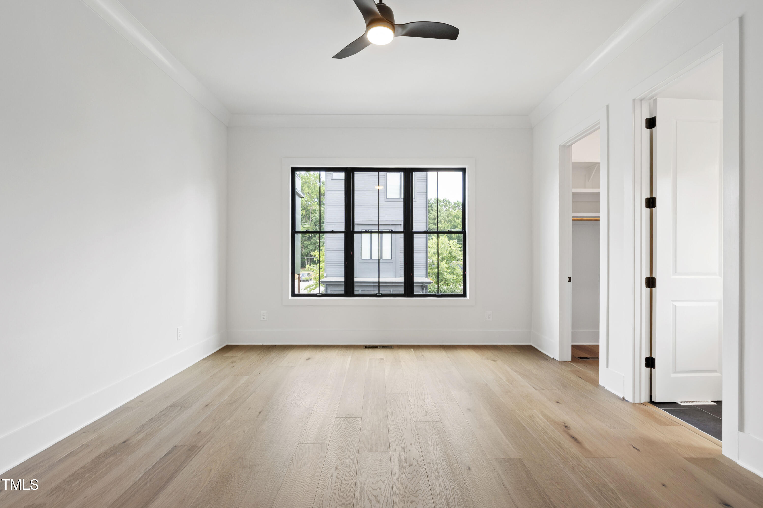 618 Velma Hopkins Lane Raleigh, NC 27603 - Photo 46 of 63 an empty room with wooden floor chandelier fan and windows