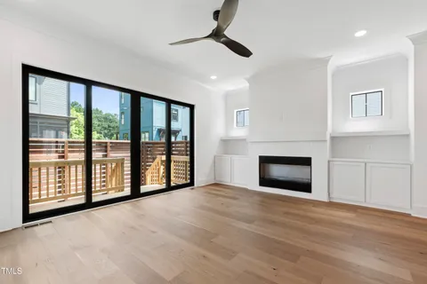 a kitchen with stainless steel appliances granite countertop a sink a stove and a wooden floor