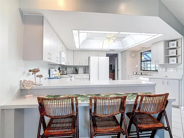 a kitchen with white cabinets appliances and a sink