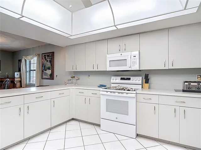 a white stove top oven sitting inside of a kitchen