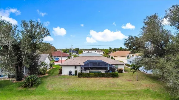 an aerial view of residential houses with outdoor space and lake view