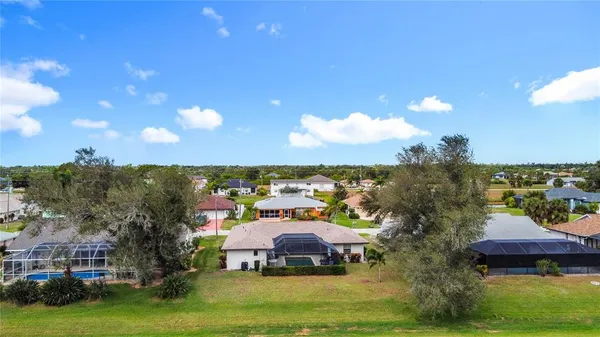 an aerial view of a houses with a swimming pool