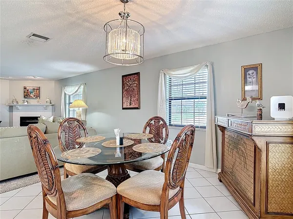 a view of a dining room with furniture a chandelier and wooden floor