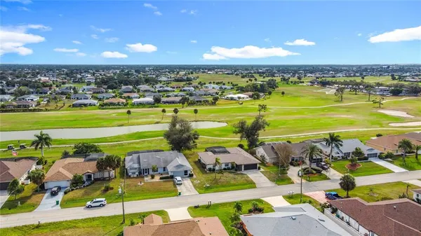 an aerial view of residential houses with outdoor space and swimming pool