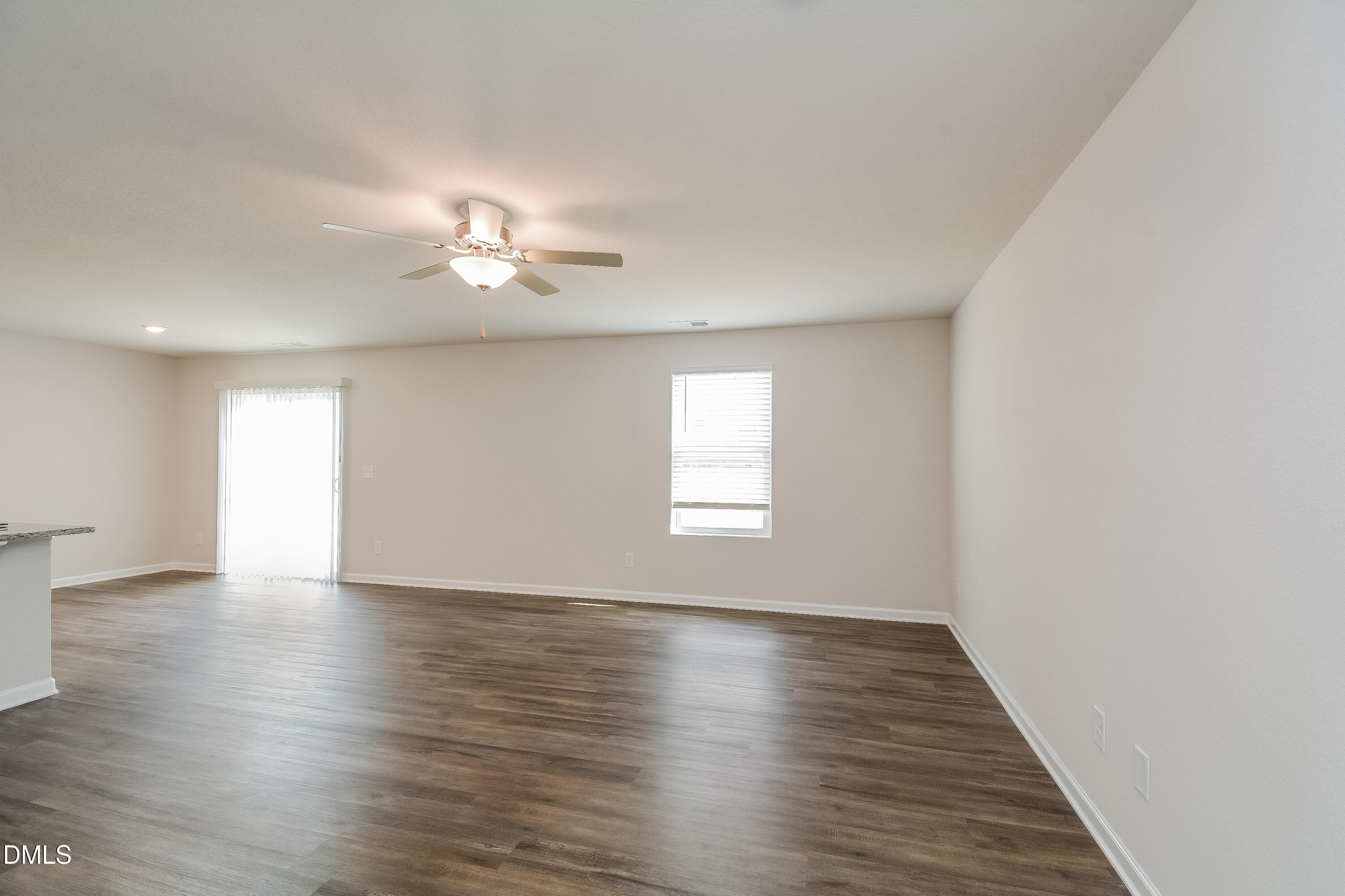 348 Gourd Street Zebulon, NC 27597 - Photo 3 of 17 an empty room with wooden floor and windows