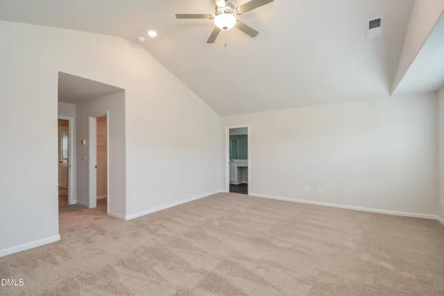 a view of an empty room with a ceiling fan
