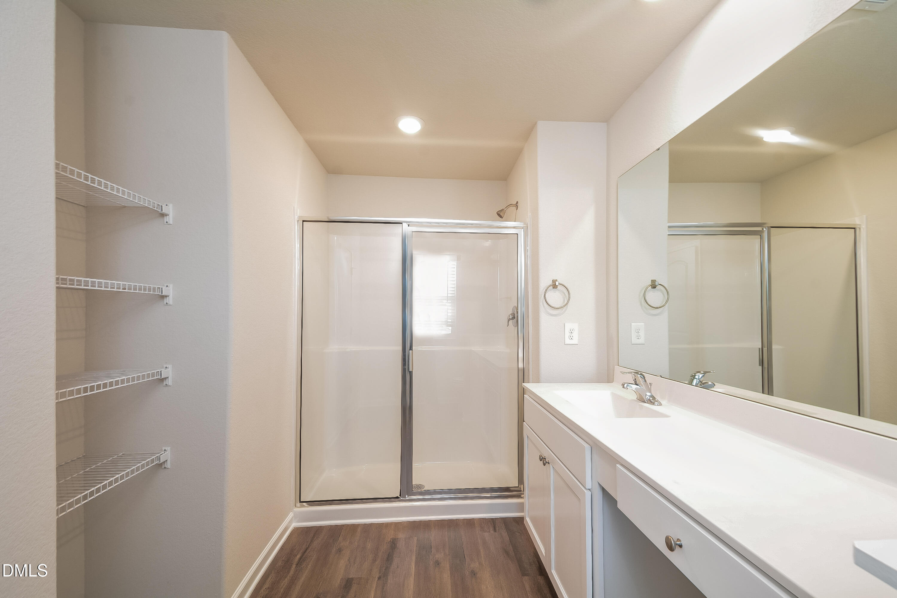 348 Gourd Street Zebulon, NC 27597 - Photo 8 of 17 a bathroom with a double vanity sink a toilet and a large mirror