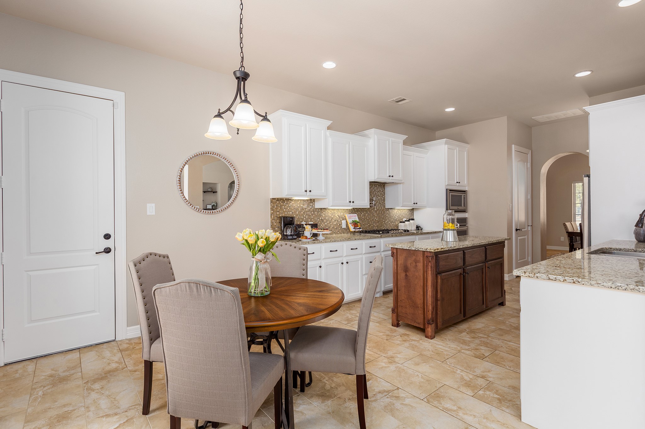 27688 Rio Blanco Drive Splendora, TX 77372 - Photo 15 of 50 a kitchen with a table chairs sink and cabinets