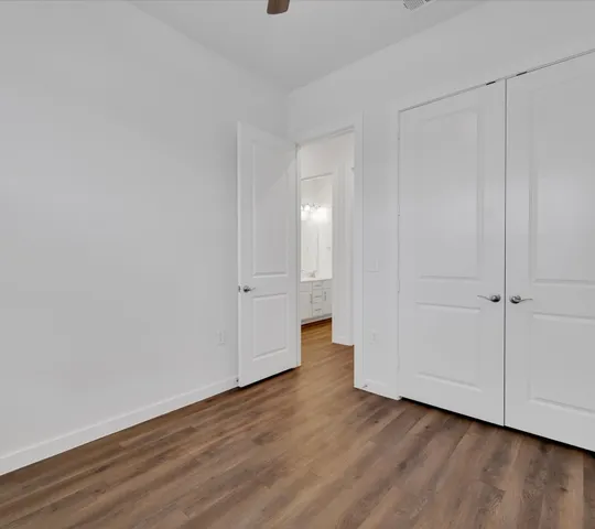 a view of a room with wooden floor