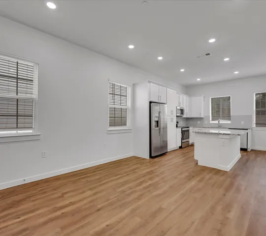a view of kitchen with wooden floor