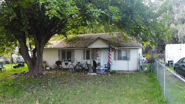 a living room with furniture kitchen view and a large window