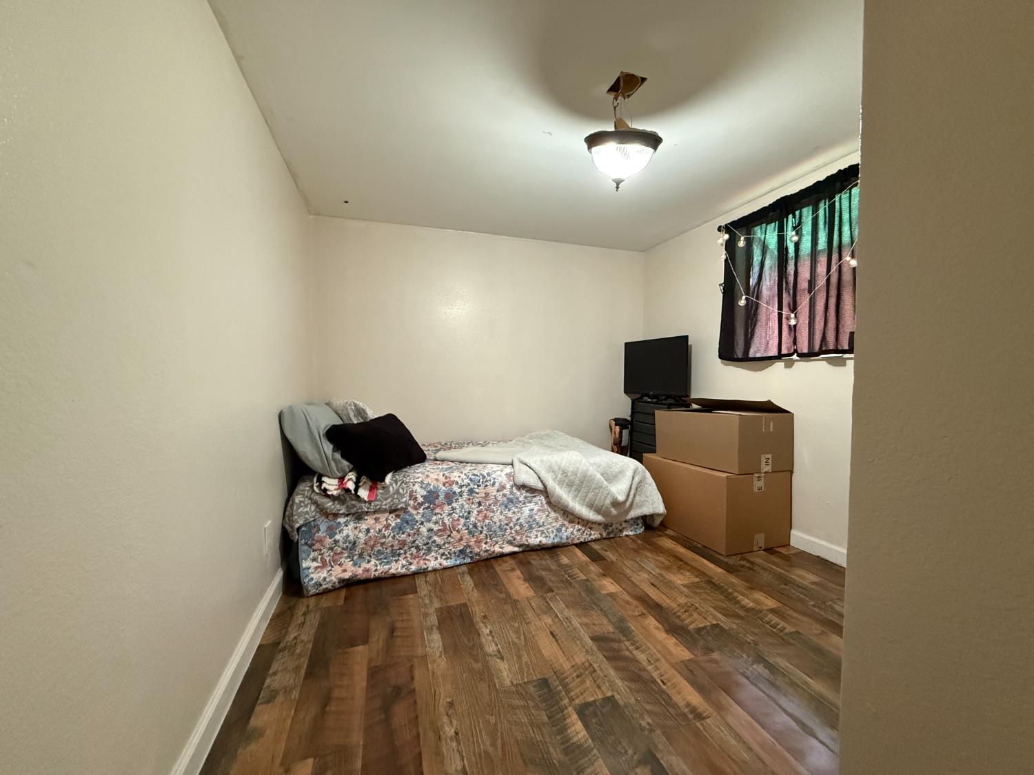 4621 Swanson Road Denair, CA 95316 - Photo 37 of 58 a bedroom with a bed and wooden floor