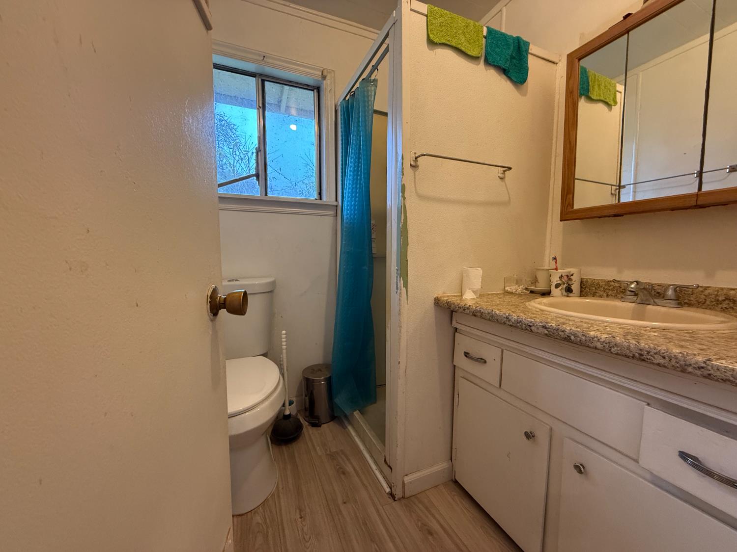 4621 Swanson Road Denair, CA 95316 - Photo 49 of 58 a bathroom with a granite countertop sink toilet and a mirror