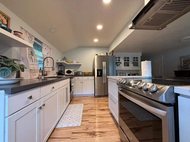 a bathroom with a granite countertop sink mirror vanity and toilet