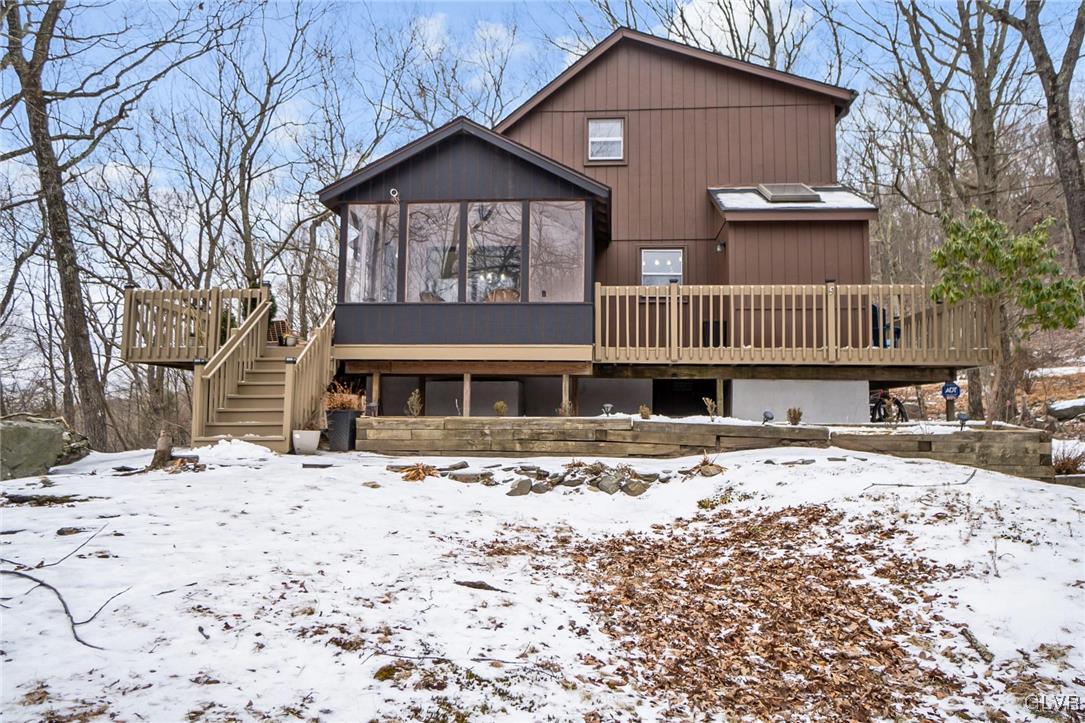 5967 Decker Road Bushkill, PA 18324 - Photo 2 of 47 a front view of a house with a yard covered in snow