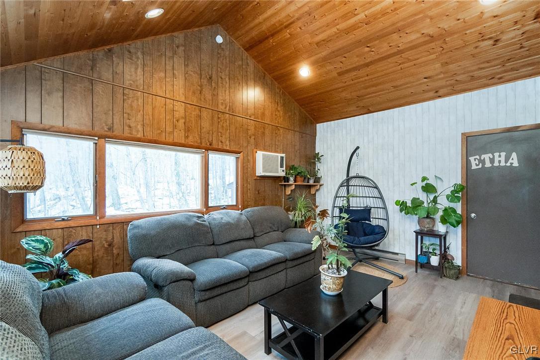 5967 Decker Road Bushkill, PA 18324 - Photo 25 of 47 a living room with furniture a wooden floor and a potted plant