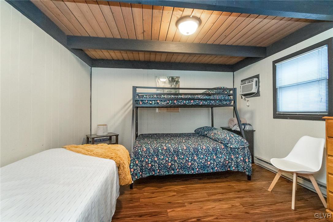 5967 Decker Road Bushkill, PA 18324 - Photo 27 of 47 a bedroom with a bed a chair and potted plant