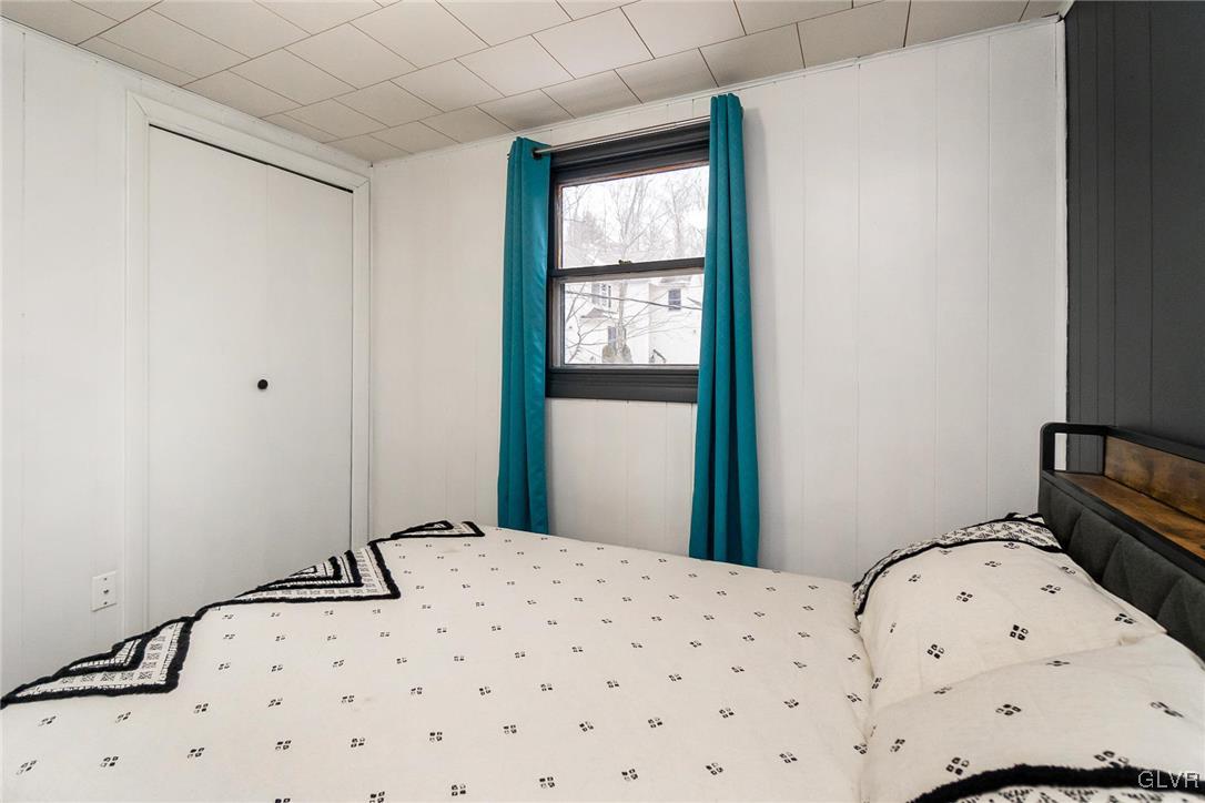 5967 Decker Road Bushkill, PA 18324 - Photo 40 of 47 a bedroom with a bed and wooden floor