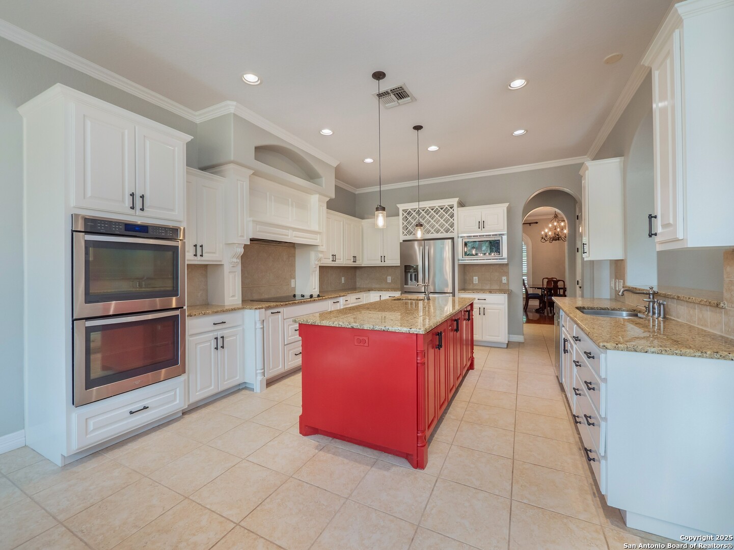 429 Fossil Hills Loop Spring Branch, TX 78070 - Photo 11 of 64 a large kitchen with stainless steel appliances kitchen island granite countertop a stove a sink dishwasher and a microwave