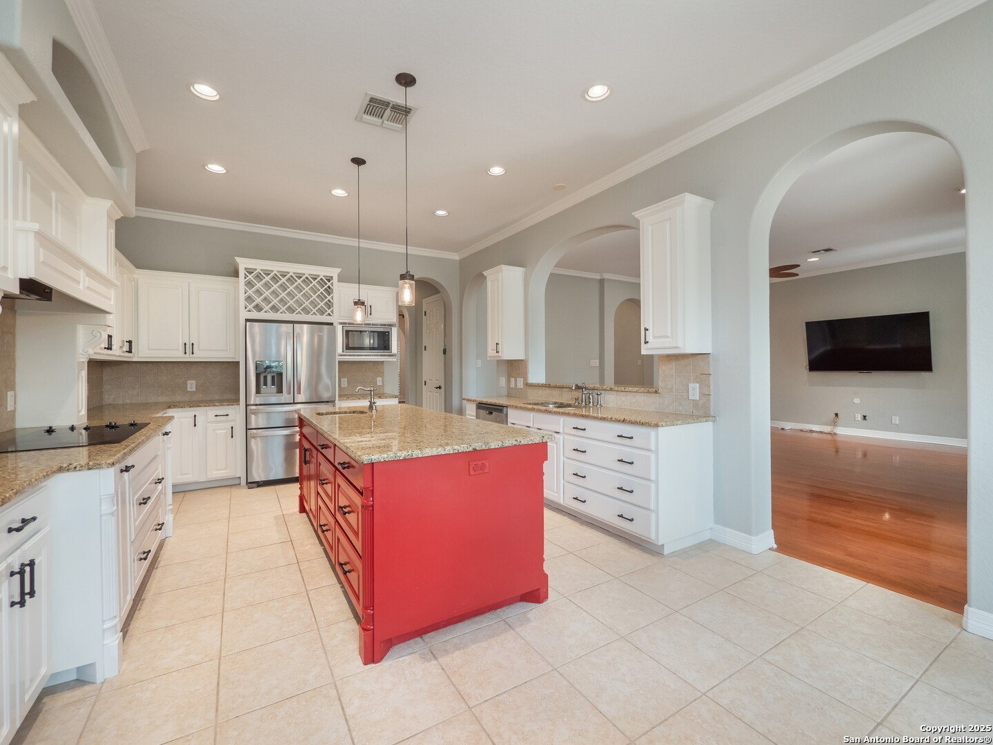 429 Fossil Hills Loop Spring Branch, TX 78070 - Photo 12 of 64 a large kitchen with stainless steel appliances kitchen island granite countertop a stove a sink and a microwave