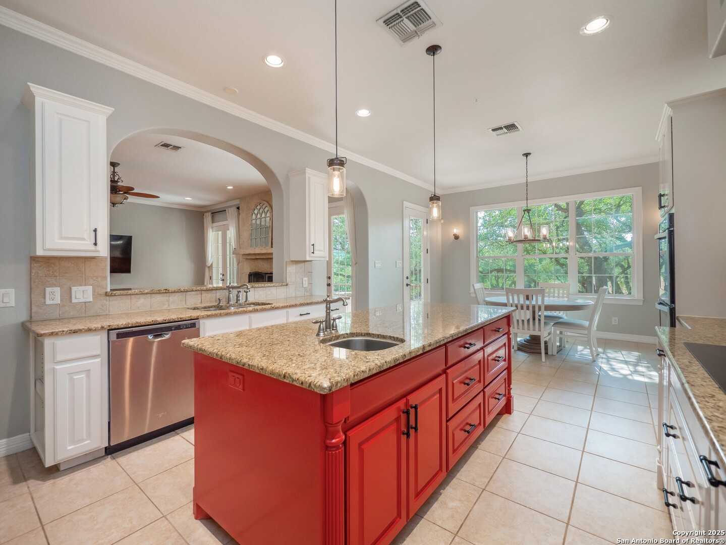 429 Fossil Hills Loop Spring Branch, TX 78070 - Photo 13 of 64 a large kitchen with kitchen island a large counter top space a sink a window and stainless steel appliances