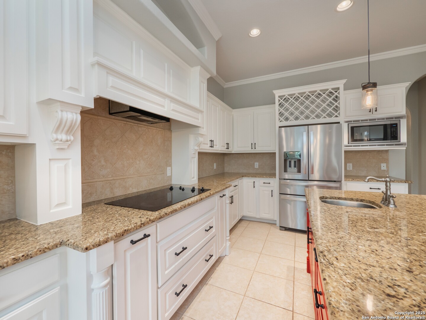 429 Fossil Hills Loop Spring Branch, TX 78070 - Photo 14 of 64 a kitchen with granite countertop a sink stainless steel appliances and cabinets