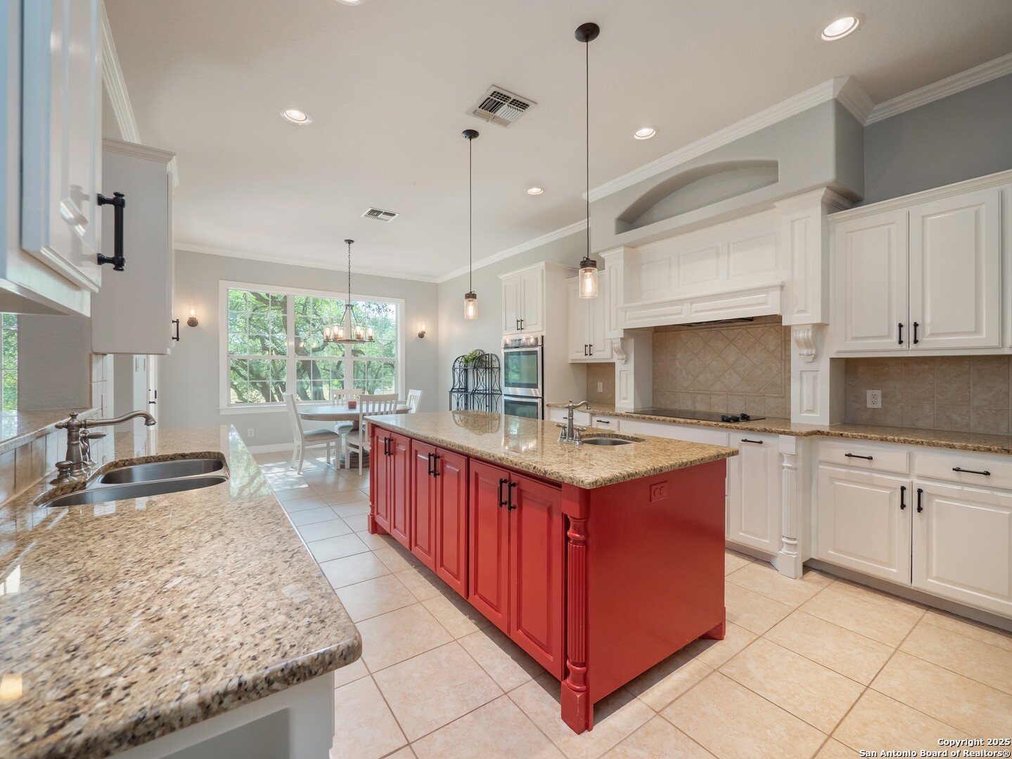 429 Fossil Hills Loop Spring Branch, TX 78070 - Photo 15 of 64 a large kitchen with kitchen island granite countertop a stove a sink dishwasher and a wooden cabinets