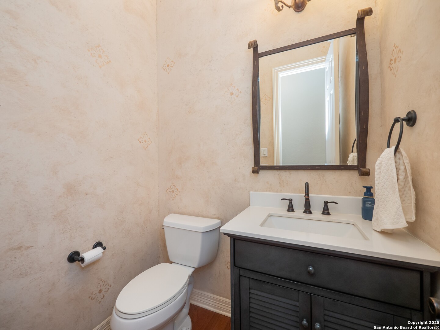 429 Fossil Hills Loop Spring Branch, TX 78070 - Photo 26 of 64 a bathroom with a toilet sink and mirror