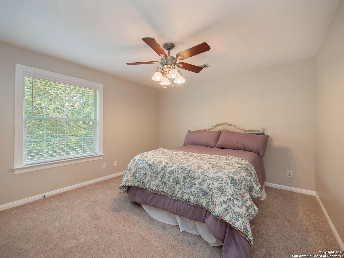 429 Fossil Hills Loop Spring Branch, TX 78070 - Photo 36 of 64 a bed sitting in a bedroom next to a window