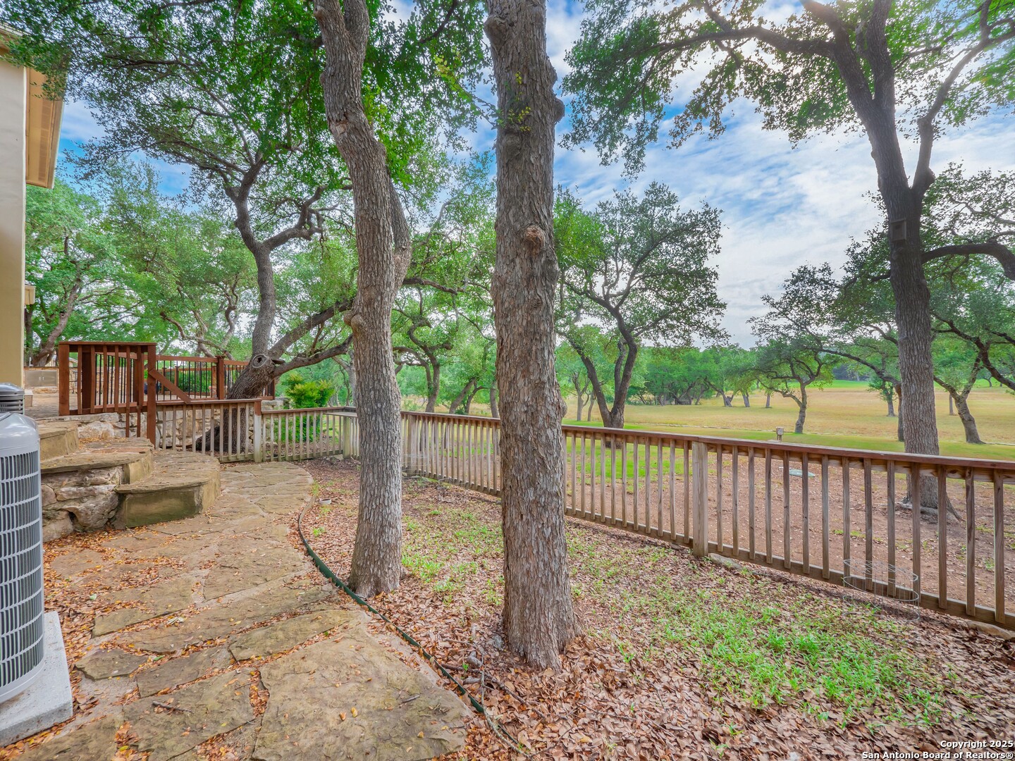429 Fossil Hills Loop Spring Branch, TX 78070 - Photo 47 of 64 a view of a backyard with large trees and wooden fence