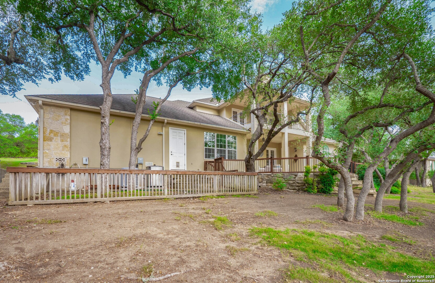 429 Fossil Hills Loop Spring Branch, TX 78070 - Photo 50 of 64 a view of a house with a small yard and a large tree