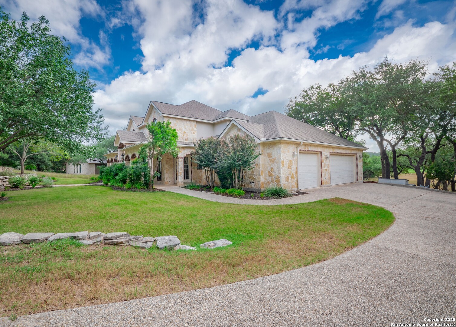 429 Fossil Hills Loop Spring Branch, TX 78070 - Photo 56 of 64 a front view of a house with garden