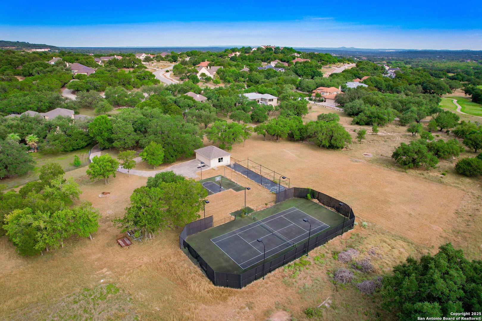 429 Fossil Hills Loop Spring Branch, TX 78070 - Photo 61 of 64 an aerial view of a house with a yard and lake view