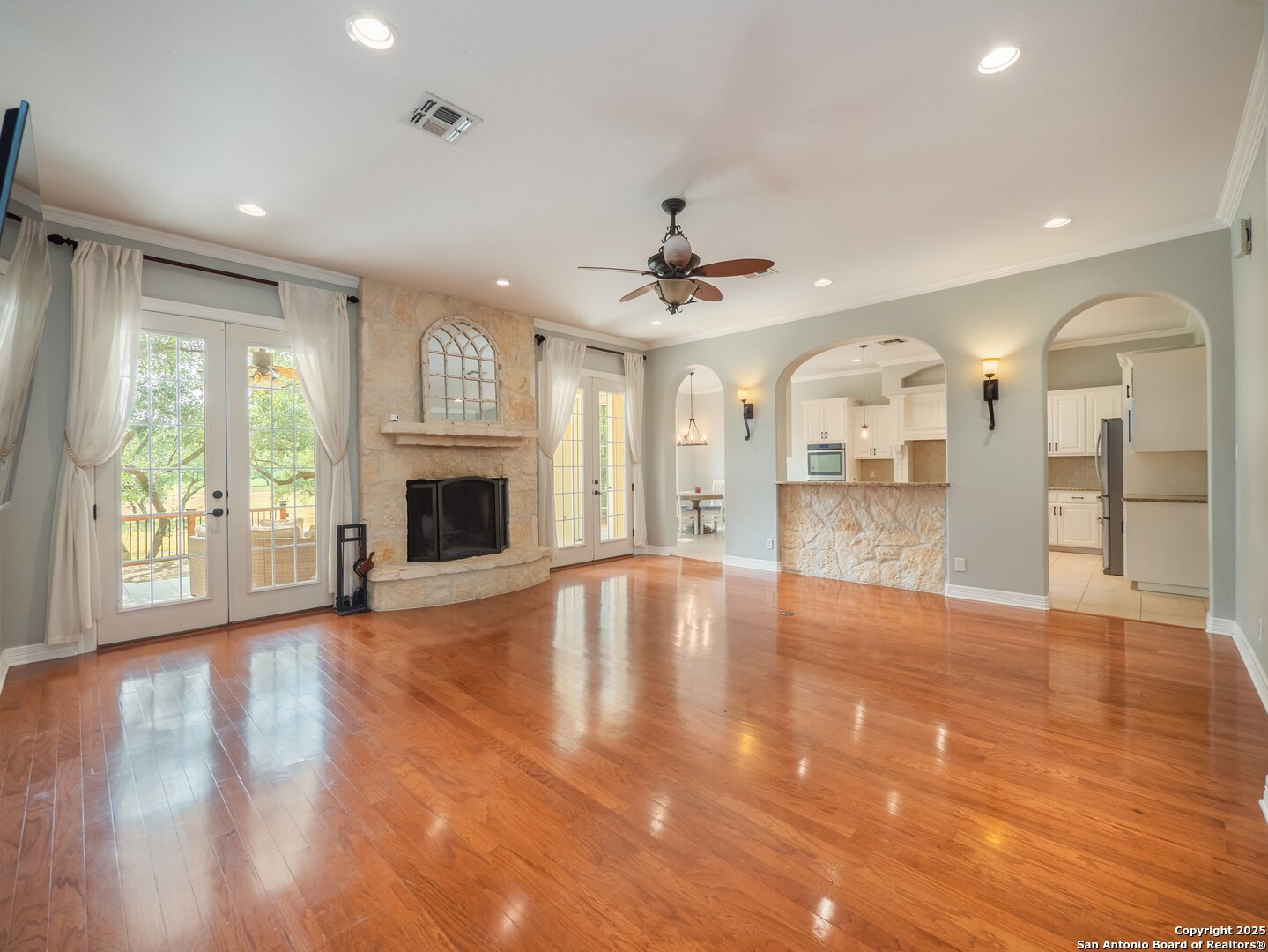 429 Fossil Hills Loop Spring Branch, TX 78070 - Photo 9 of 64 a view of an empty room with window and wooden floor