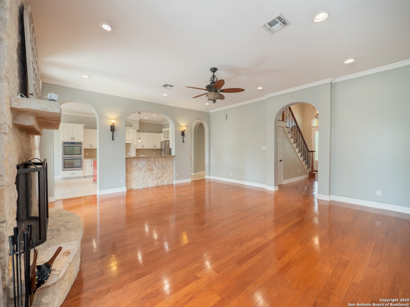 429 Fossil Hills Loop Spring Branch, TX 78070 - Photo 10 of 64 a view of an empty room with wooden floor and a ceiling fan