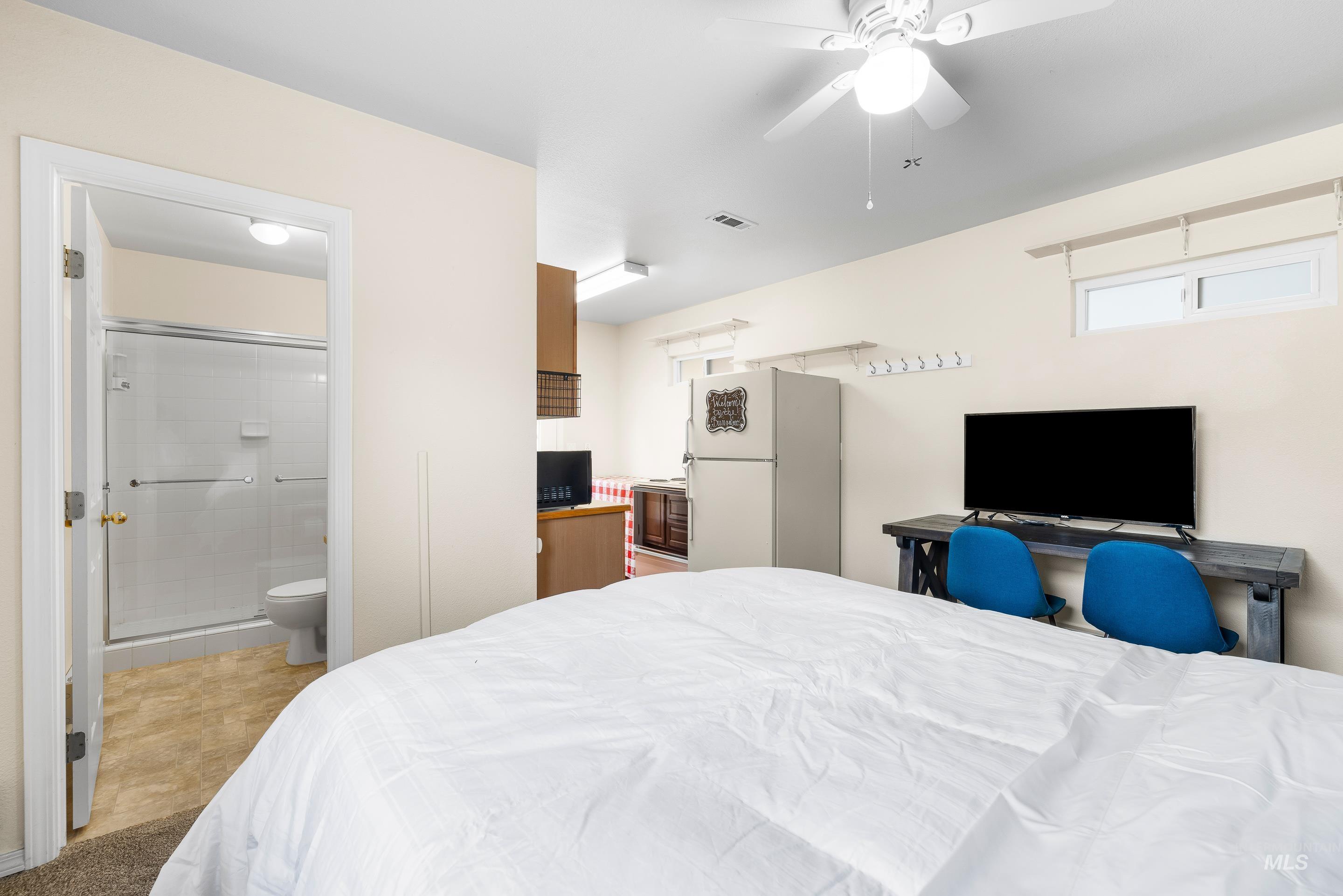 7736 West Bayhill Street Boise, ID 83704 - Photo 45 of 50 Bedroom with freestanding refrigerator, ceiling fan, and a desk